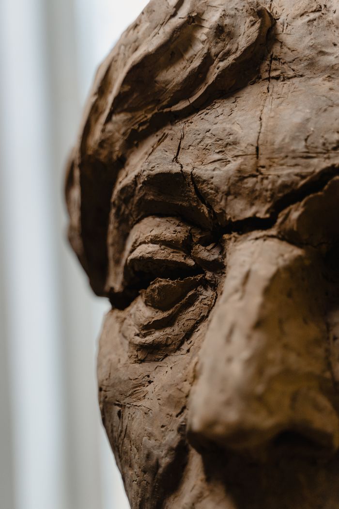 Detailed close-up of a handmade clay sculpture showcasing intricate texture and artistry.